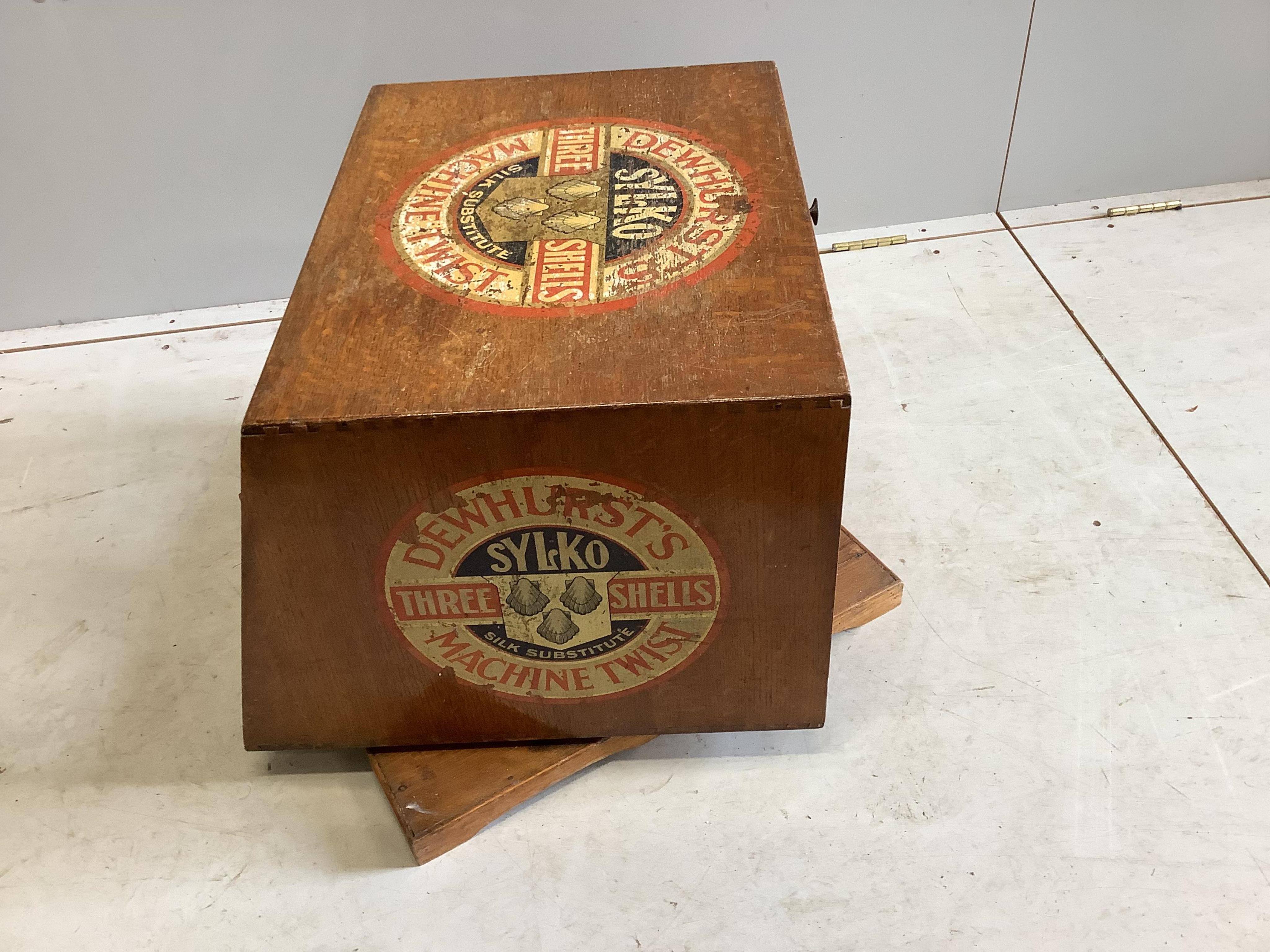 An early 20th century oak counter top display case, “Dewhurst’s Sylko Three Shells Machine Twist”, on swivel base, width 54cm, depth 52cm, height 42cm. Condition - fair